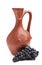 Traditional clay jug for wine with bunch grapes