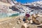 Traditional clothing woman sitting resting lake mountain shore, Bolivia travel.