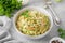 Traditional cole slaw salad in a bowl on a gray concrete background. Salad with cabbage, carrot and mayonnaise sauce.