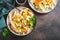 Traditional cole slaw salad of cabbage, carrots and greens on a plate top view