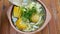 Traditional Colombian ajiaco soup close up in a bowl on the table. horizontal view from above