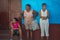 Traditional Colonial Caribbean town people woman with classic colorful house and wall in Trinidad, Cuba, America.