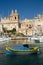 Traditional colorful maltese fishing boat in harbor of Malta