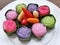 Traditional colorful sweet Thai desserts on a white plate