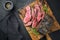 Traditional Commonwealth Sunday roast with sliced cold cuts roast beef with thyme and spice on a rustic wooden cutting board