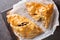 Traditional Cornish pasty filled with meat potato swede and carrot closeup on the paper. Horizontal top view