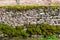 Traditional cotswold stone wall with moss