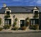 TRADITIONAL COTTAGE WITH HANGING BASKETS, BRITTANY, FRANCE