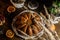 Traditional country style italian Christmas cake wrapped with lace with chocolate, fruits and coffee wooden background