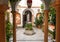 Traditional courtyard with columns, vintage sculptures and decor of Andalusia. Historical houses in Spain