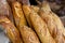 Traditional crusty French bread baguette in basket at bakery. Fresh organic pastry at local market. France cuisine background