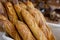 Traditional crusty French bread baguette in basket at bakery. Fresh organic pastry at local market. France cuisine background