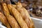 Traditional crusty French bread baguette in basket at bakery. Fresh organic pastry at local market. France cuisine background