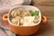 Traditional cuisine. Ravioli, pelmeni with sour cream on wooden table. Flat lay, close up.