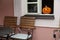 Traditional decorative orange yellow pumpkin for Halloween in the open window of a street cafe restaurant.