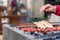 Traditional delicious Adana kebab on a barbecue with grilled tomatoes, close up