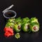 Traditional delicious fresh Chuka syake sushi roll set on a black background with reflection