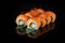 Traditional delicious fresh sushi roll set on a black background with reflection. Sushi roll with rice, nori, cream cheese, tobiko