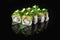 Traditional delicious fresh sushi roll set on a black background with reflection. Sushi roll with rice, nori, cream cheese, tobiko