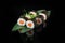 Traditional delicious fresh sushi roll set on a black background with reflection. Sushi roll with rice, nori, cream cheese, tobiko