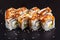 Traditional delicious fresh Unagi sushi roll set on a black background with reflection