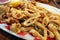 Traditional delicious fried calamari rings with fried vegetables