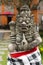 Traditional demon guard statue carved in stone on Bali