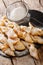 Traditional dessert Angel Wings Dusted with powdered sugar close-up. vertical