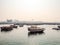 Traditional dhow boats moored in the port near Museum of Islamic Art Park at sunset