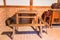 Traditional dining room with tables and chairs.