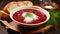 A traditional dish of Russian and Ukrainian cuisine. Borscht with herbs and sour cream on a wooden table in a beautiful