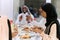 A traditional and diverse Muslim family comes together to share a delicious iftar meal during the sacred month of