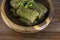 Traditional dolma in grape leaves on wooden table