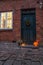 Traditional door with cobblestone street and halloween decoratio