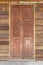 Traditional double wooden door on the Old plank wood vintage style wall for background and texture