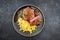 Traditional dry aged sliced roast beef with fried onion rings and Swabian spaetzle on a modern style plate