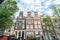Traditional Dutch architecture with a row of tall thin buildings and three gables rising like towers