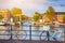 Traditional Dutch Bicycles In Amsterdam Against Bridge in the Background