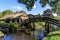 Traditional dutch brick houses with lush green lawns on a water canal in Giethoorn village, Netherlands