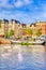 Traditional Dutch Cityscape Of Amsterdam With Barge in the Foreground At Daytime