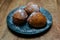 Traditional Dutch doughnut on a plate, with powder sugar on it. Called oliebollen in the Netherlands. Mostly eaten on New Year`s E