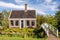 Traditional Dutch old house and garden. White bridge across the canal. Holland.