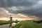 Traditional dutch windmill under a dramatic thundery sky during sundown