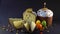 Traditional Easter cake on dark black background. Migdal, candied fruits, raisins, decor colorful eggs, candles are burning. Secti