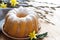 Traditional easter cake sprinkled with powdered sugar, decoration with catkins and flowers