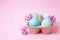 Traditional easter card template with pastel colors painted organic eggs in wicker basket with hay and decorative wildflowers.