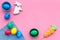 Traditional easter design with colorful eggs and rabbit and carrot cookie on pink background top view space for text