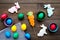 Traditional easter design with colorful eggs and rabbit and carrot cookie on wooden background top view space for text