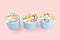 Traditional Easter Portuguese candies. Colorful Sweets in a blue paper cups on pink background