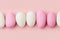 Traditional Easter Portuguese candies. White and pink sweets on pastel pink background